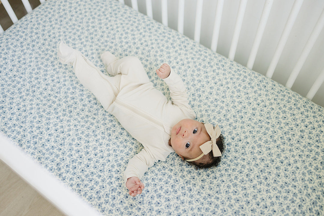 Soft, breathable, and durable, the Mebie Baby Blue Blossom Muslin Crib Sheet ranks among the best crib sheets.