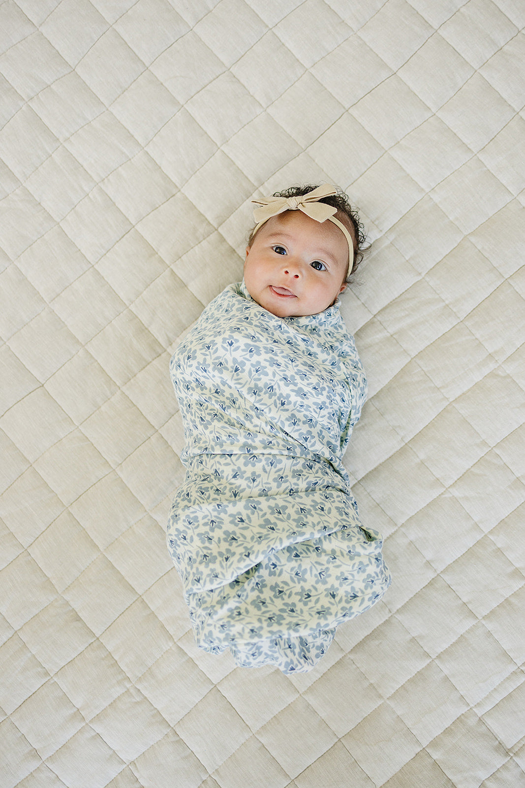 Snuggle your newborn in the Mebie Baby Blue Blossom Muslin Swaddle Blanket, perfect as a muslin swaddle blanket.