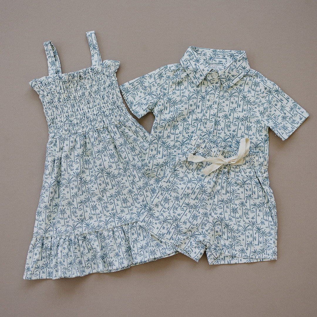 Styled flat lay of the Palm Tree Linen Dress, a popular tropical baby dress from Mebie Baby
