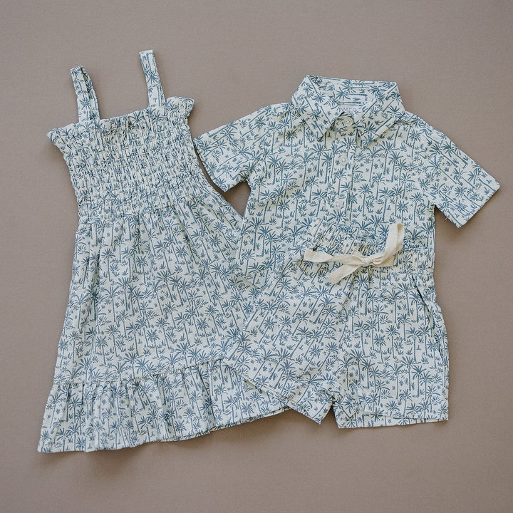 Styled flat lay of the Palm Tree Linen Dress, a popular tropical baby dress from Mebie Baby