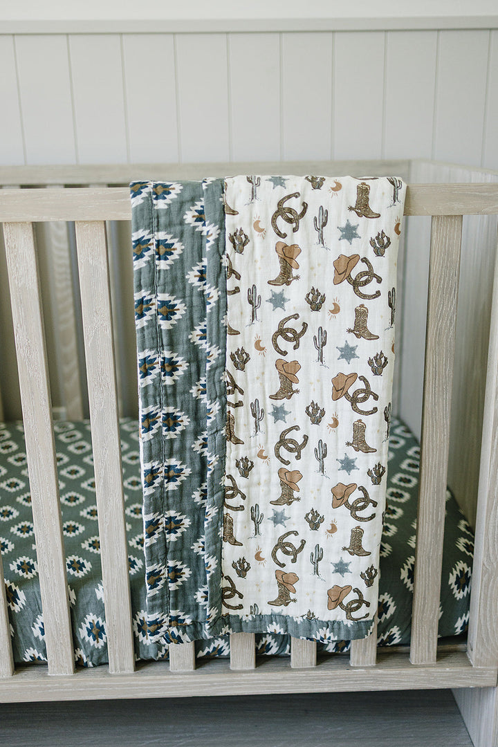 The Mebie Baby Southwest Aztec Muslin Crib Sheet provides a snug, breathable fit as premium crib bed sheets.