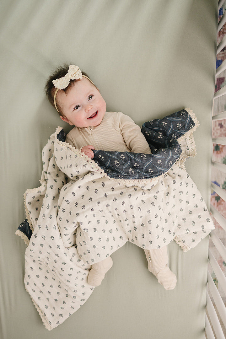Mebie Baby Navy Berry + Cream Berry Lace Muslin Quilt makes a charming kids blanket for naps or playtime.