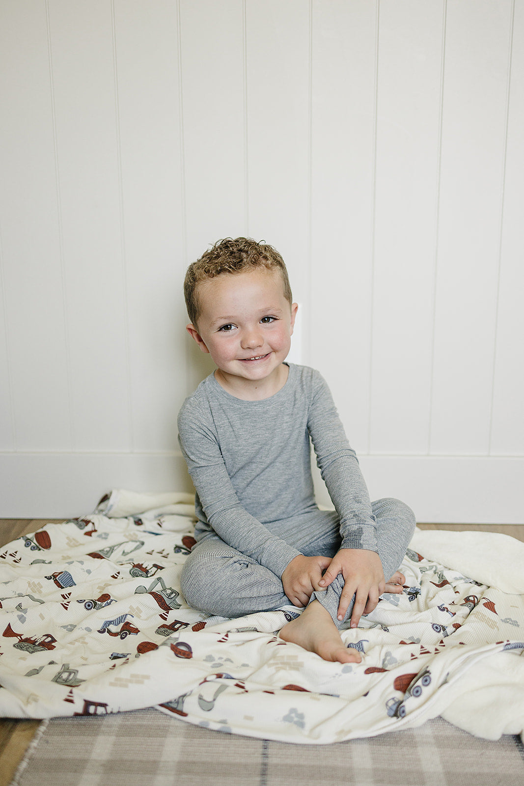 Wrap your child in the Mebie Baby Construction Trucks Ribbed Bamboo Fleece Quilt, perfect as a kids blanket.