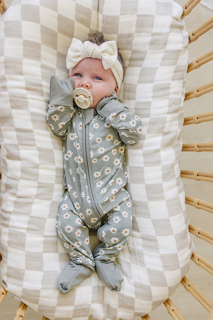 Toddler wearing the Mebie Baby Light Green Daisy Bamboo Zipper in a cozy nursery setting