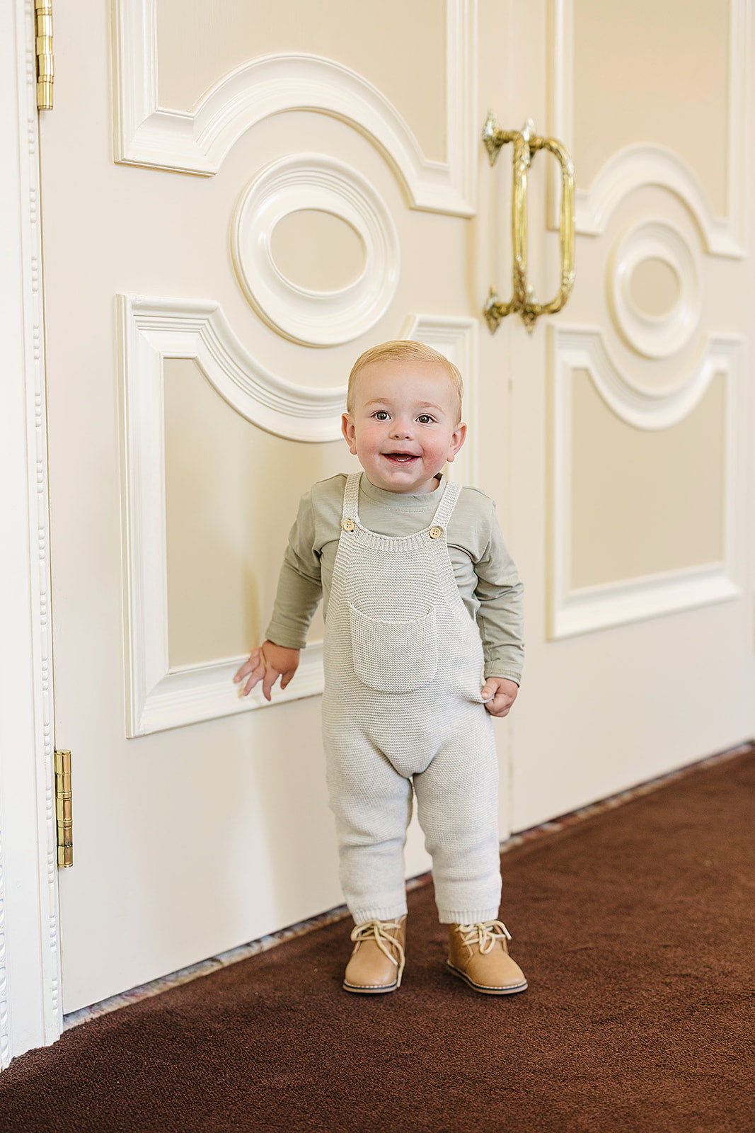 Shown on a little one, the Mebie Baby Grey Knit Overalls fit perfectly within newborn baby clothes collections