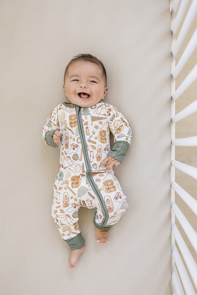 Baby wearing the ribbed organic bamboo zip-up pajamas