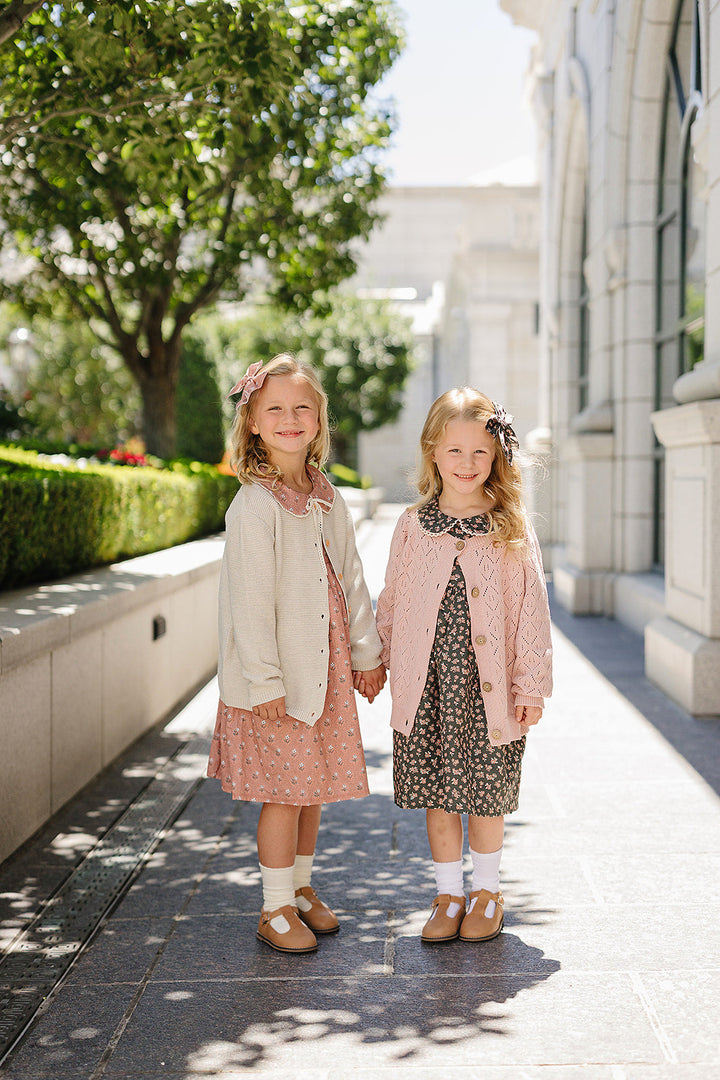 Keep little ones warm in the Mebie Baby Pink Pointelle Button Down Cardigan, a staple in organic baby clothes