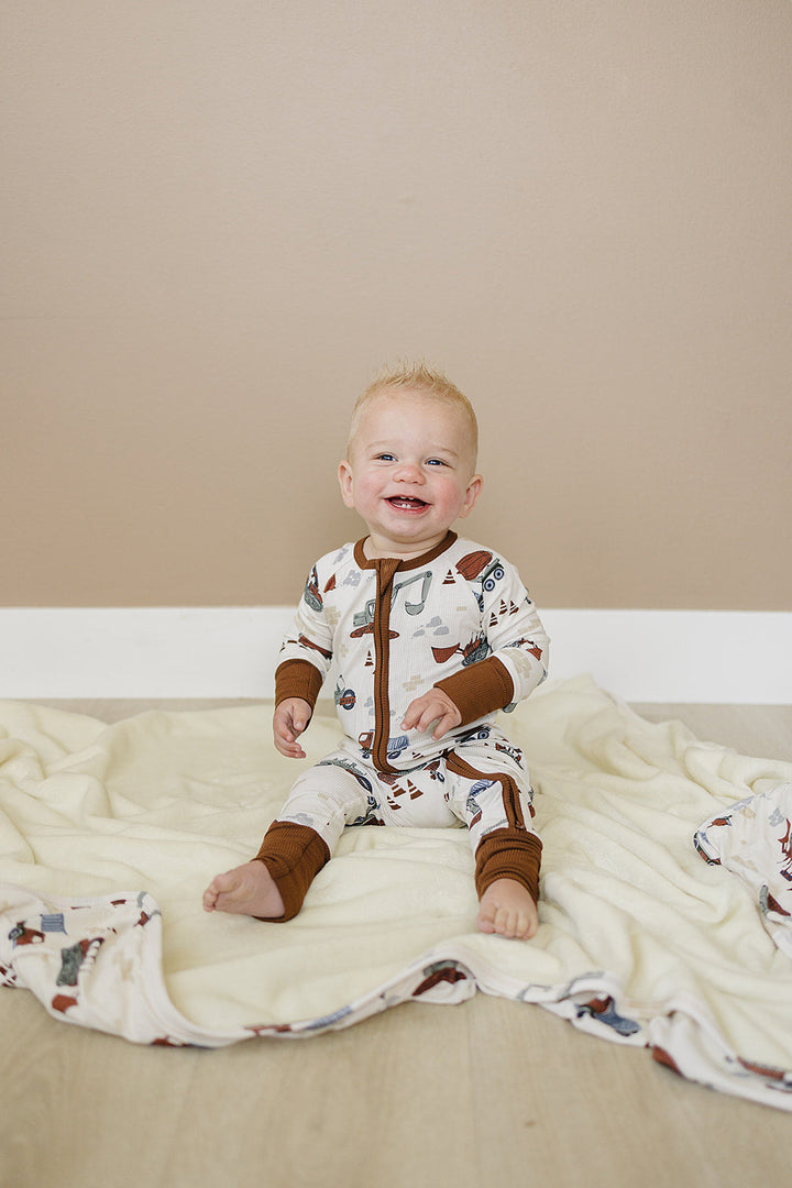 Soft and cozy, the Mebie Baby Construction Trucks Ribbed Bamboo Fleece Quilt works as one of the best baby blankets.