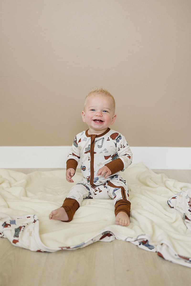 Soft and cozy, the Mebie Baby Construction Trucks Ribbed Bamboo Fleece Quilt works as one of the best baby blankets.