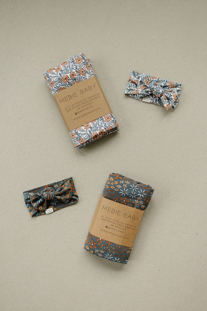 Cuddle your infant in the Mebie Baby Navy Floral Bamboo Stretch Swaddle, a gentle baby swaddle wrap.