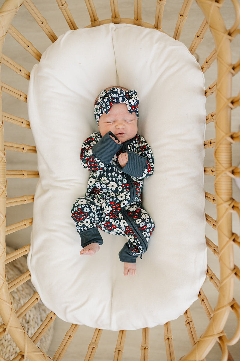 A red, white, and blue floral look defines the Mebie Baby Americana Floral Ribbed Bamboo Zipper, ideal for newborn onesies