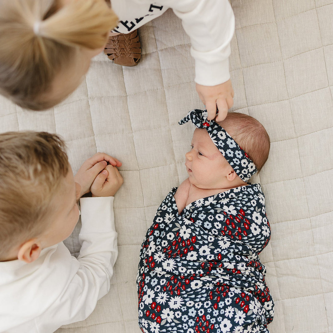 Soft and stretchy, the Mebie Baby Americana Floral Ribbed Bamboo Stretch Swaddle works as one of the best swaddles for babies.