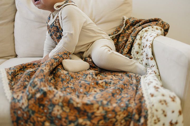 Wrap your child in the Mebie Baby Venetian Floral + Autumn Bloom Lace Muslin Quilt, a cozy muslin baby blanket.