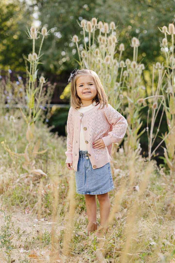 The Mebie Baby Pink Pointelle Button Down Cardigan features delicate knit texture, perfect for newborn baby clothes