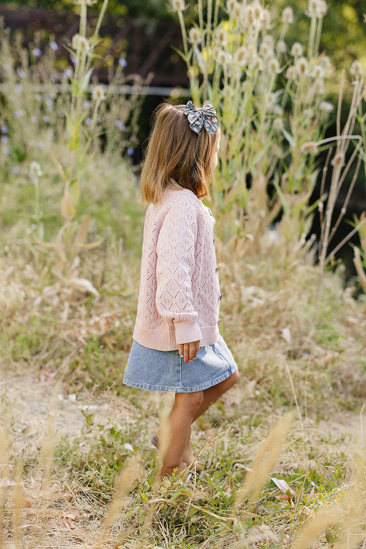 A sweet layer for little outfits, the Mebie Baby Pink Pointelle Button Down Cardigan fits perfectly in baby clothing