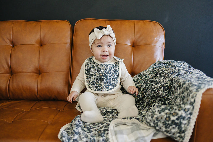 Nursery essential, Mebie BabyÕs Liberty Floral + Coastal Plaid Lace Muslin Quilt works as a soft muslin quilt.