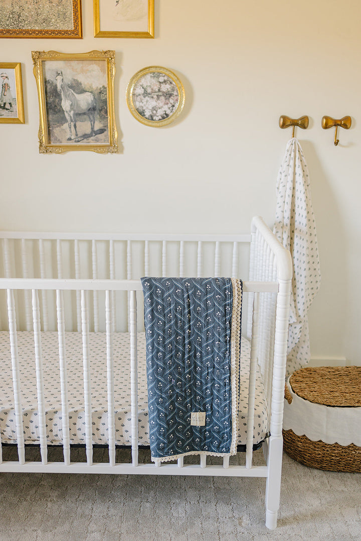 The Mebie Baby Navy Berry + Cream Berry Lace Muslin Quilt is soft and versatile, perfect as a muslin blanket.