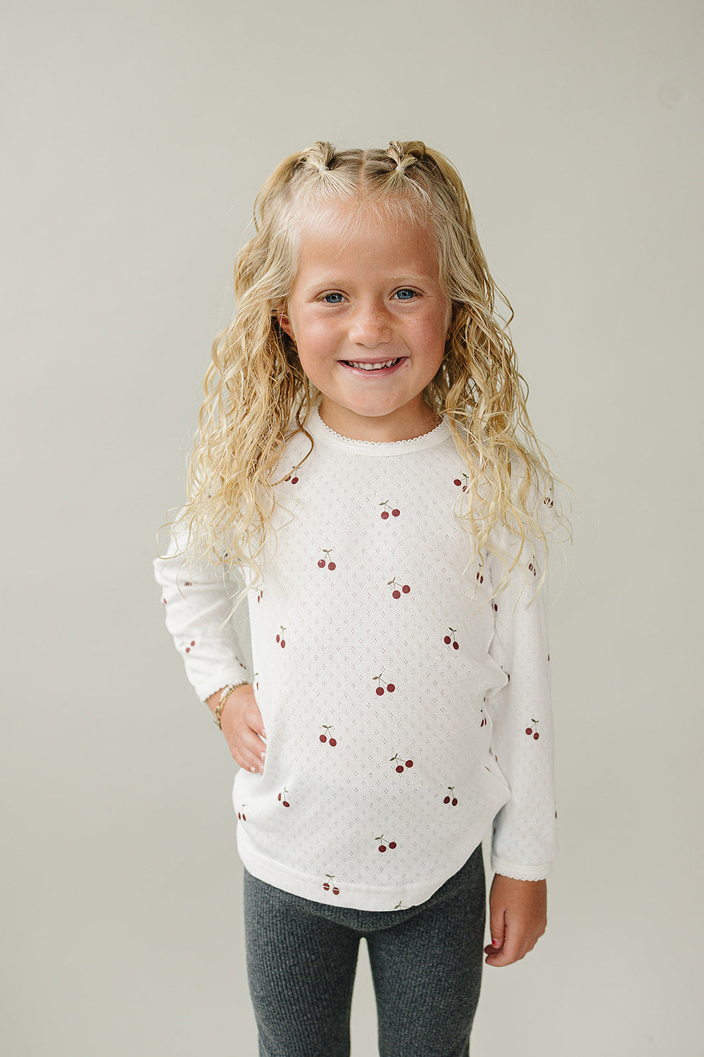 The Mebie Baby Cherry Pointelle Long Sleeve Tee features delicate knit texture, perfect for newborn baby clothes