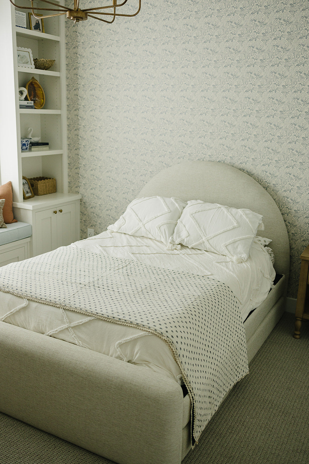 Folded neatly, the Navy Berry + Cream Berry Lace Twin Muslin Quilt from Mebie Baby is a breathable cotton muslin blanket.