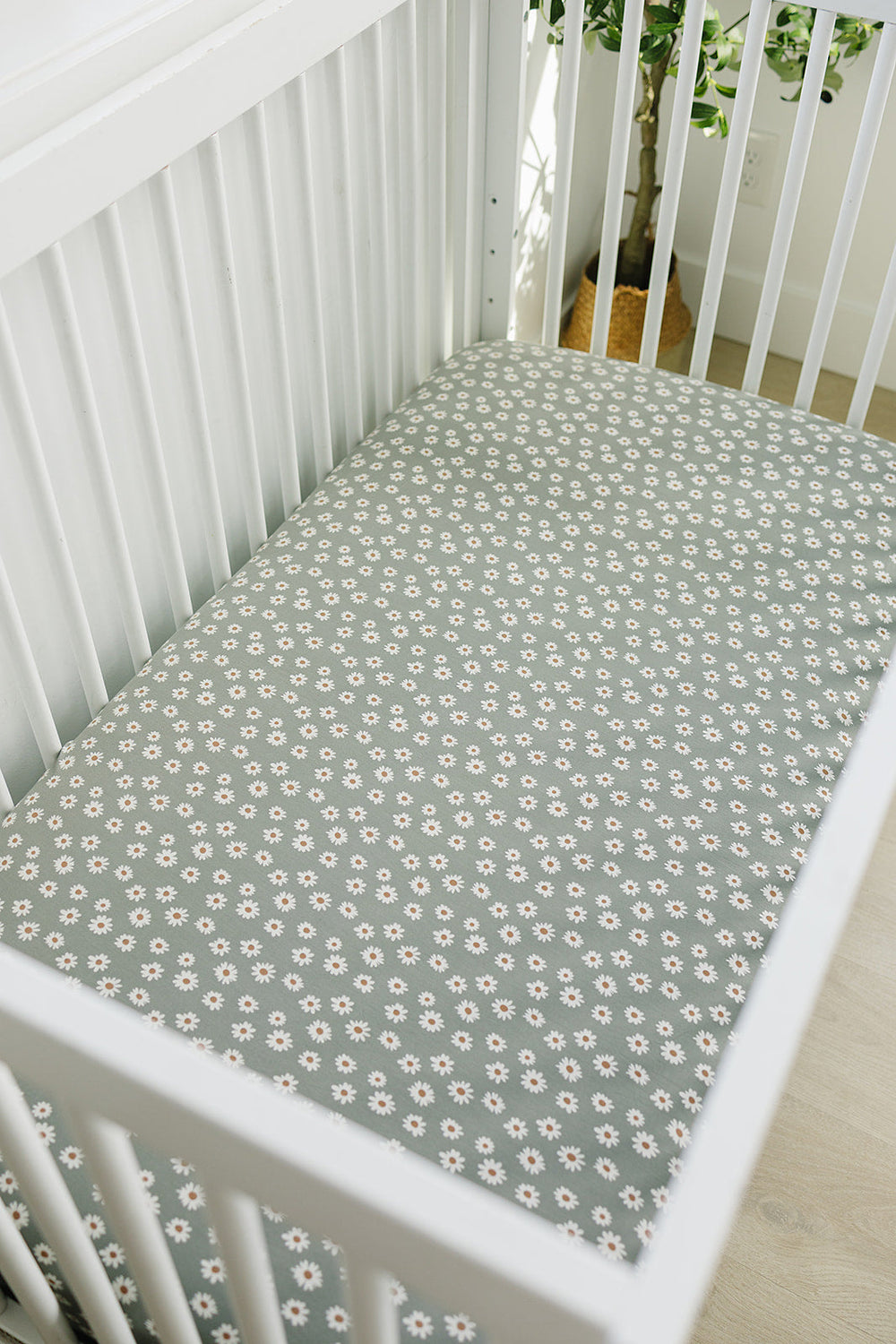 The Light Green Daisy Bamboo Stretch Crib Sheet by Mebie Baby makes fitted crib sheets stylish and comfortable.