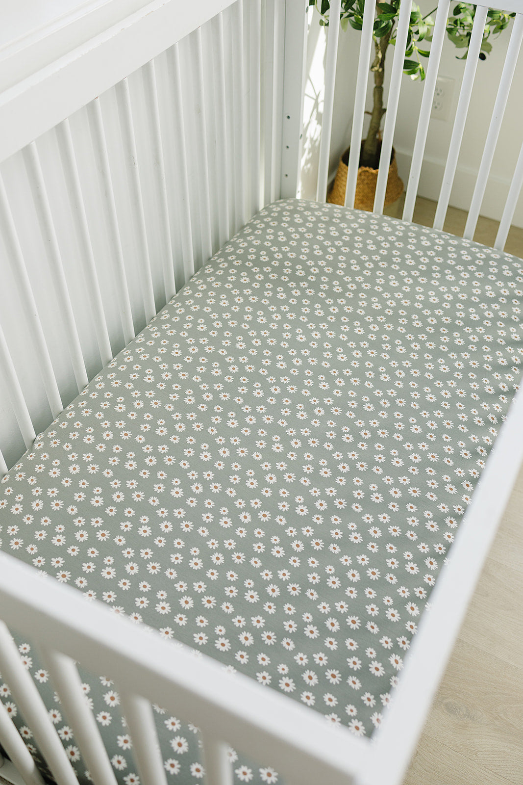 The Light Green Daisy Bamboo Stretch Crib Sheet by Mebie Baby makes fitted crib sheets stylish and comfortable.