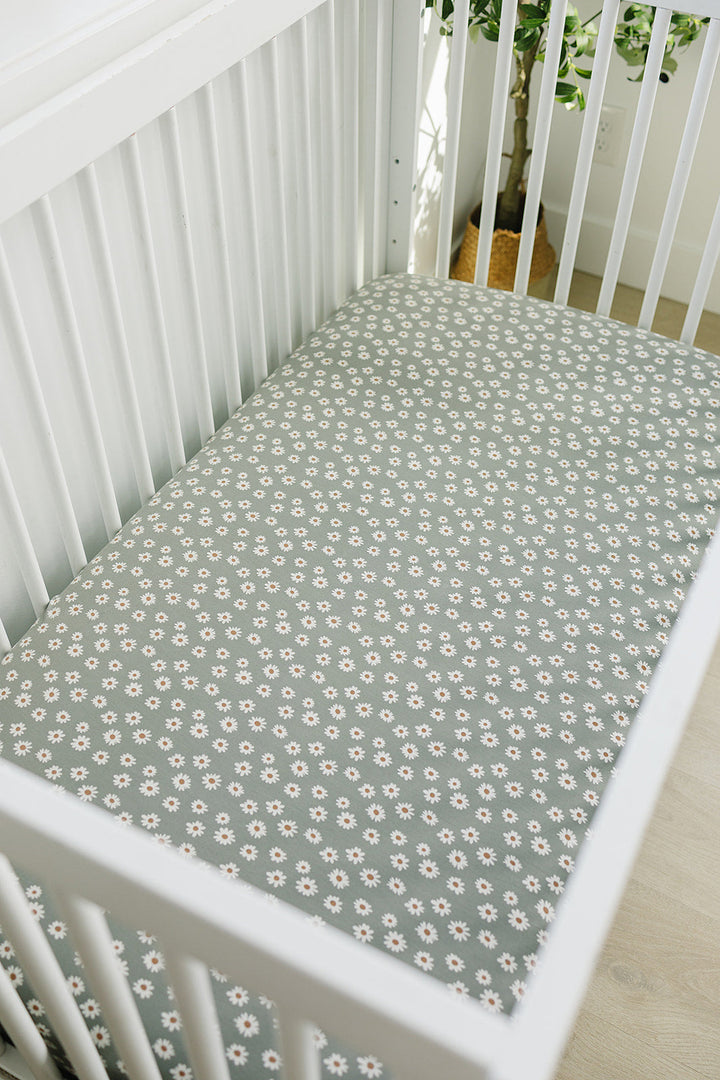 The Light Green Daisy Bamboo Stretch Crib Sheet by Mebie Baby makes fitted crib sheets stylish and comfortable.