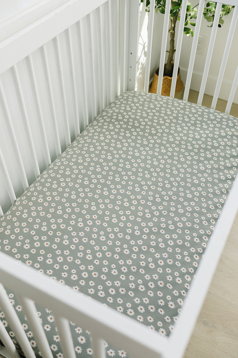 The Light Green Daisy Bamboo Stretch Crib Sheet by Mebie Baby makes fitted crib sheets stylish and comfortable.