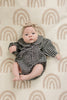 Infant wearing the gingham collared romper by Mebie Baby.