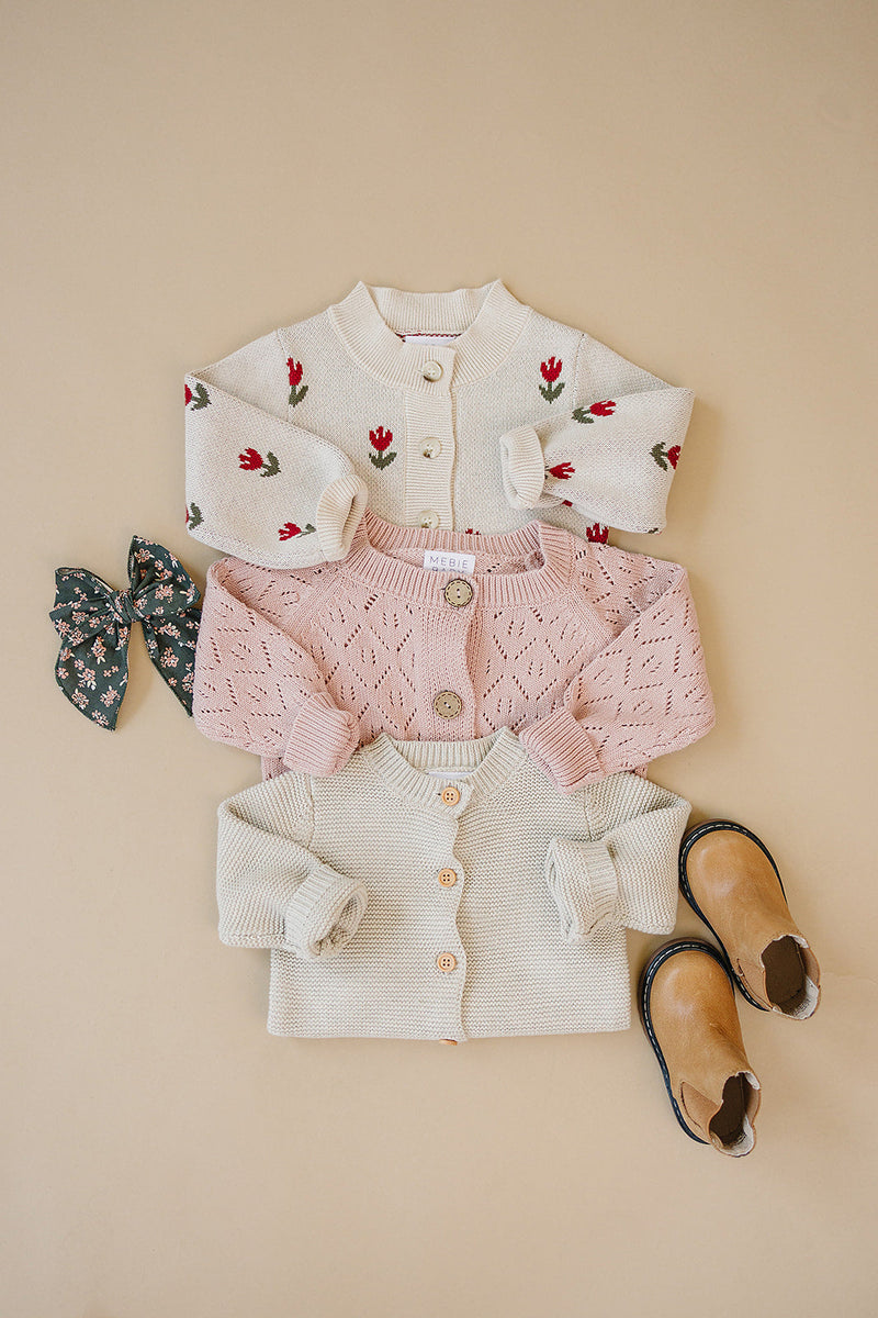 Shop baby clothes online with the Mebie Baby Pink Pointelle Button Down Cardigan, a versatile wardrobe essential