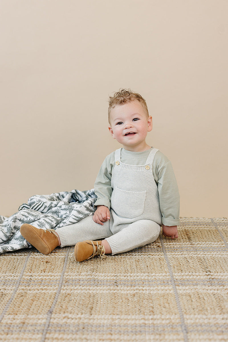The Mebie Baby Grey Knit Overalls offer a neutral tone, ideal for parents choosing organic baby clothes