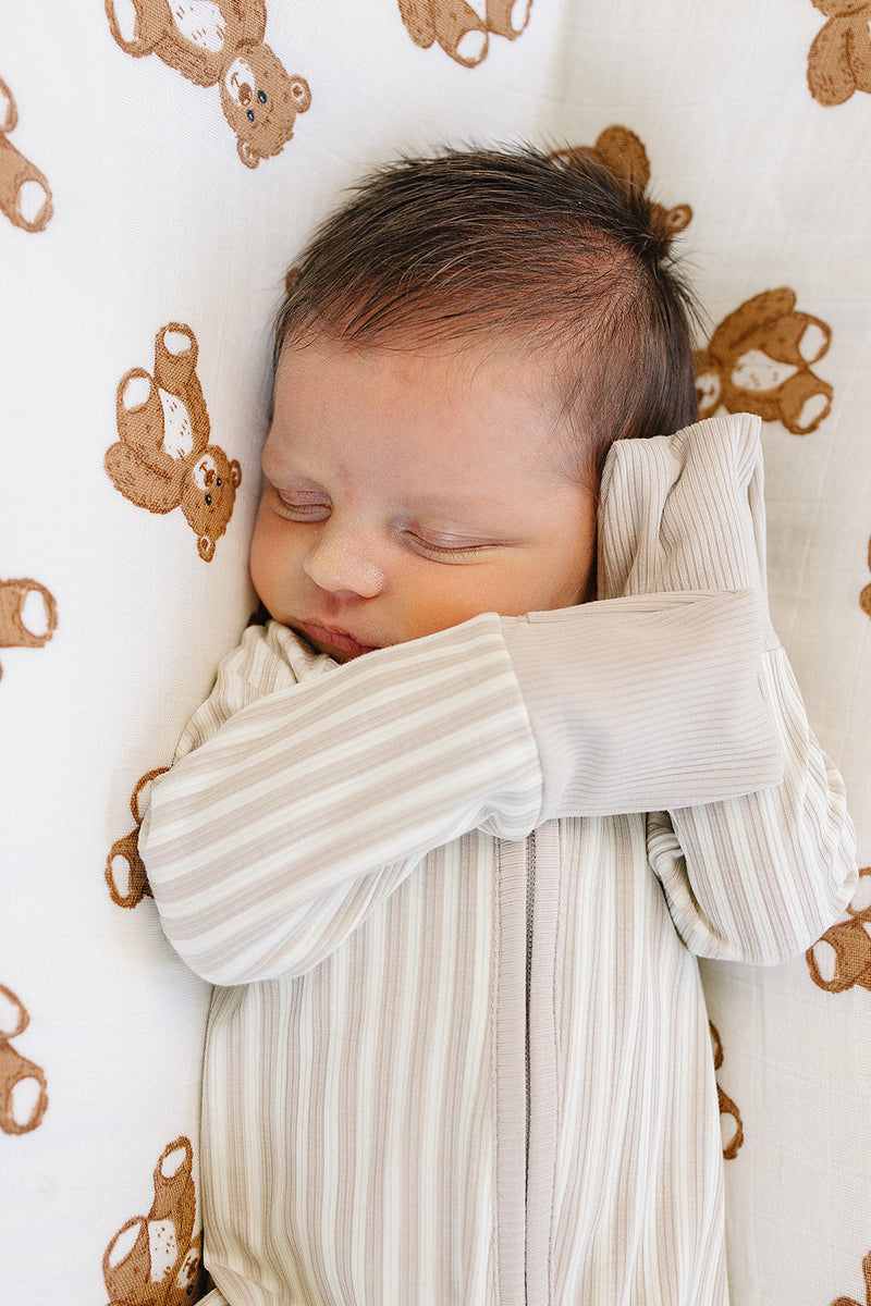 A subtle taupe stripe pattern defines the Mebie Baby Taupe Stripe Ribbed Bamboo Zipper, ideal for newborn onesies