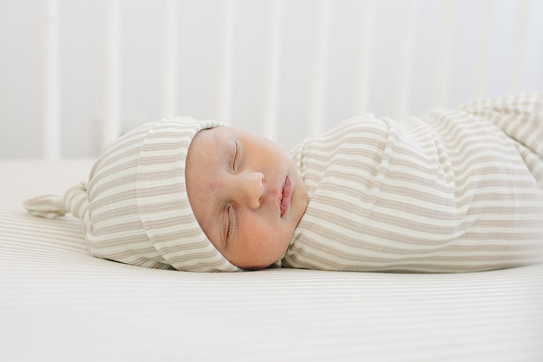 Cuddle your infant in the Mebie Baby Taupe Stripe Ribbed Bamboo Stretch Swaddle, a gentle baby swaddle wrap.