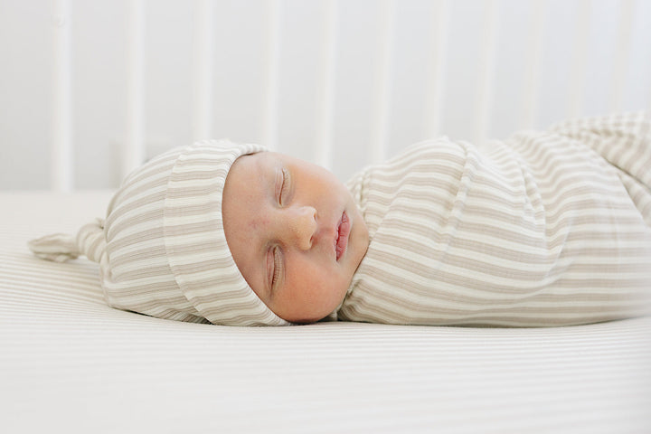 Cuddle your infant in the Mebie Baby Taupe Stripe Ribbed Bamboo Stretch Swaddle, a gentle baby swaddle wrap.