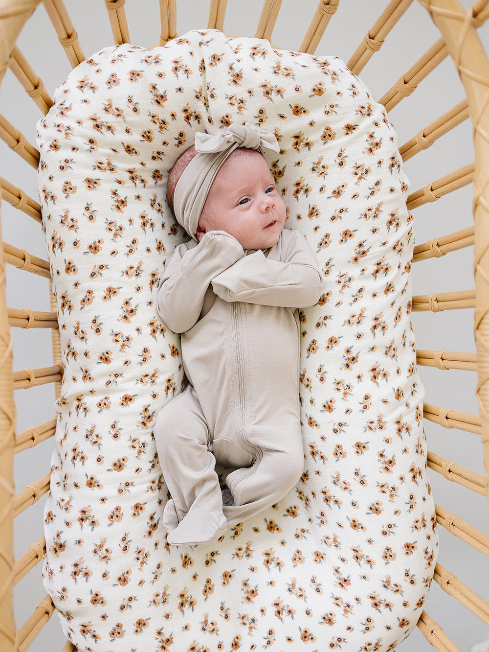Laid flat to show the ribbed fabric, the Oatmeal Bamboo Footed Zipper from Mebie Baby.