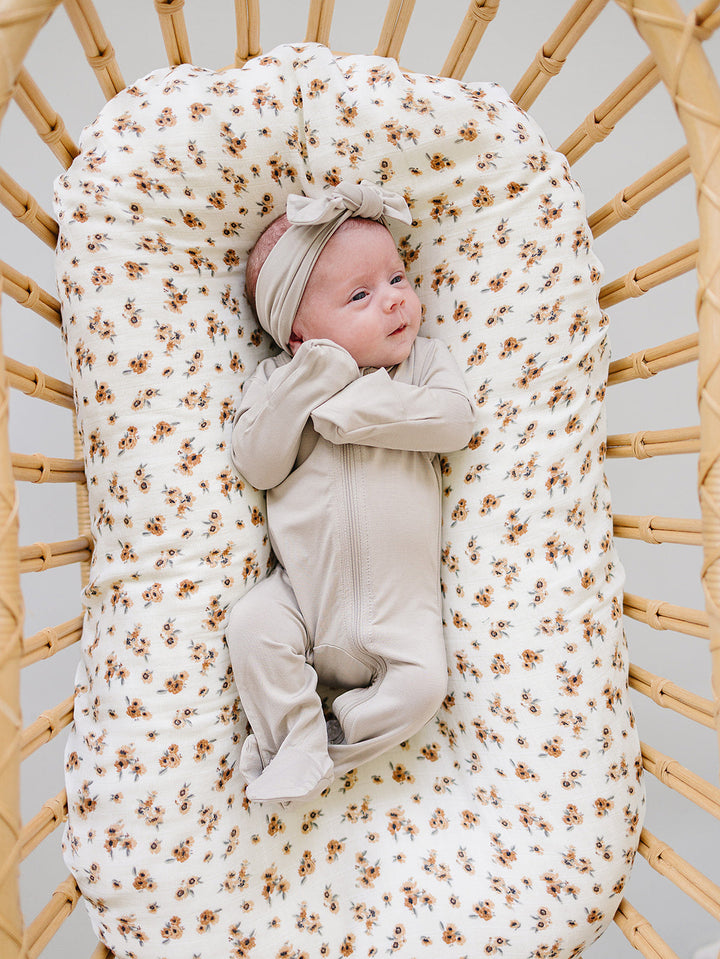Laid flat to show the ribbed fabric, the Oatmeal Bamboo Footed Zipper from Mebie Baby.