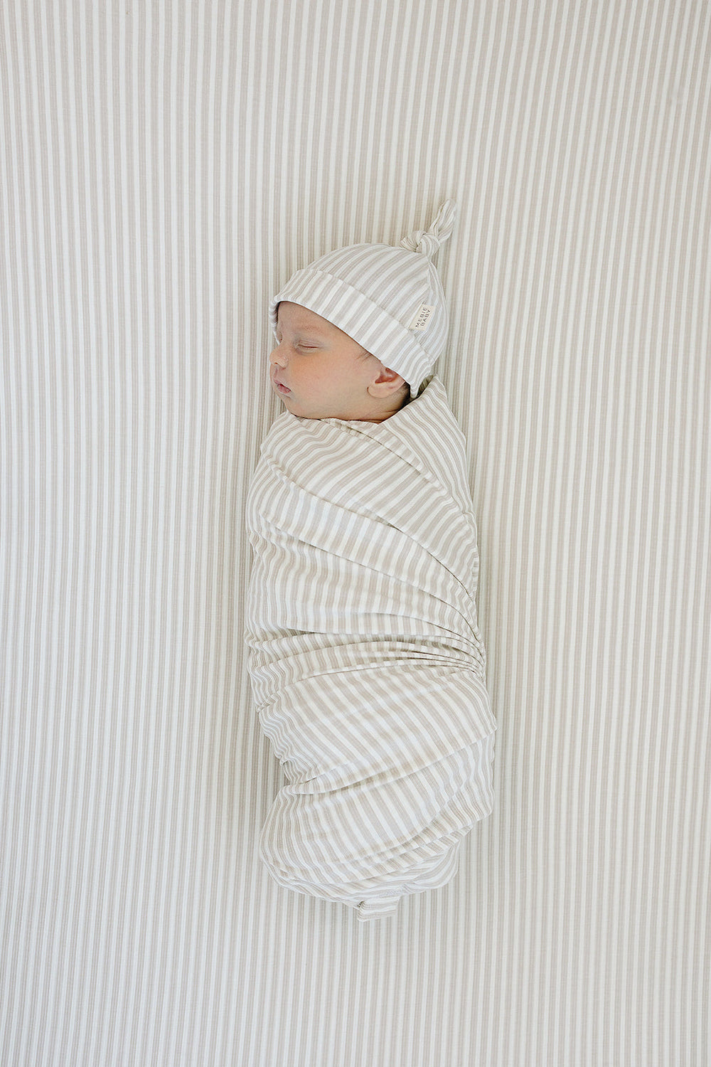Soft and stretchy, the Mebie Baby Taupe Stripe Ribbed Bamboo Stretch Crib Sheet is perfect for fitted crib sheets.