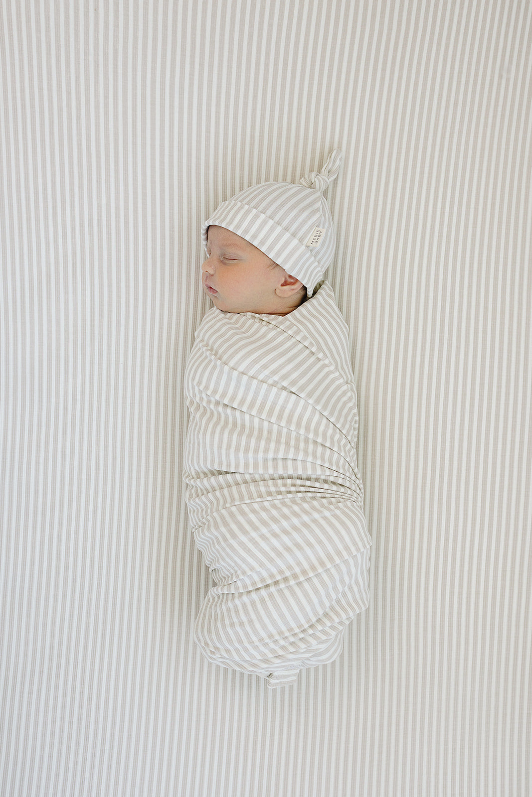 Soft and stretchy, the Mebie Baby Taupe Stripe Ribbed Bamboo Stretch Crib Sheet is perfect for fitted crib sheets.