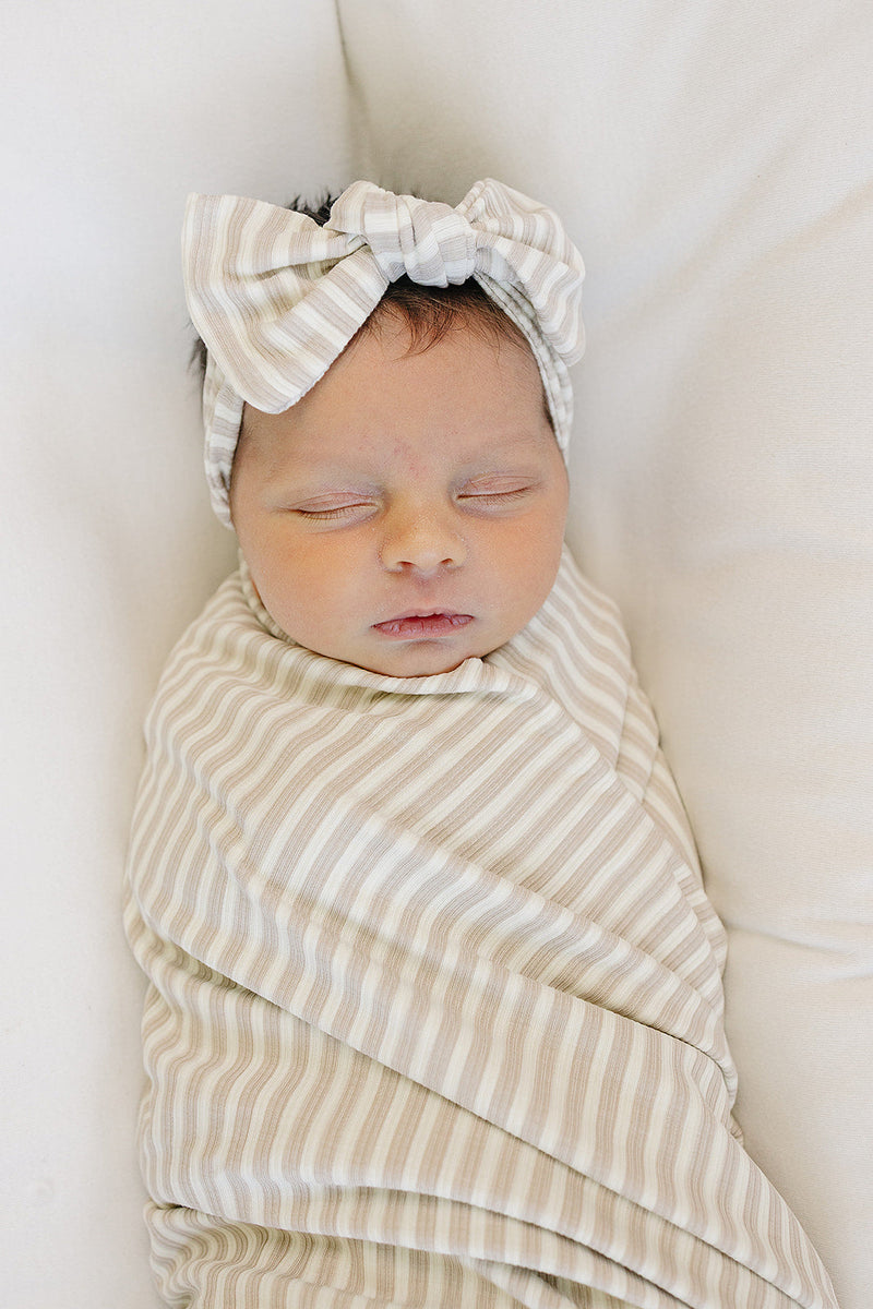 Soft and stretchy, the Mebie Baby Taupe Stripe Ribbed Bamboo Stretch Swaddle works as one of the best swaddles for babies.