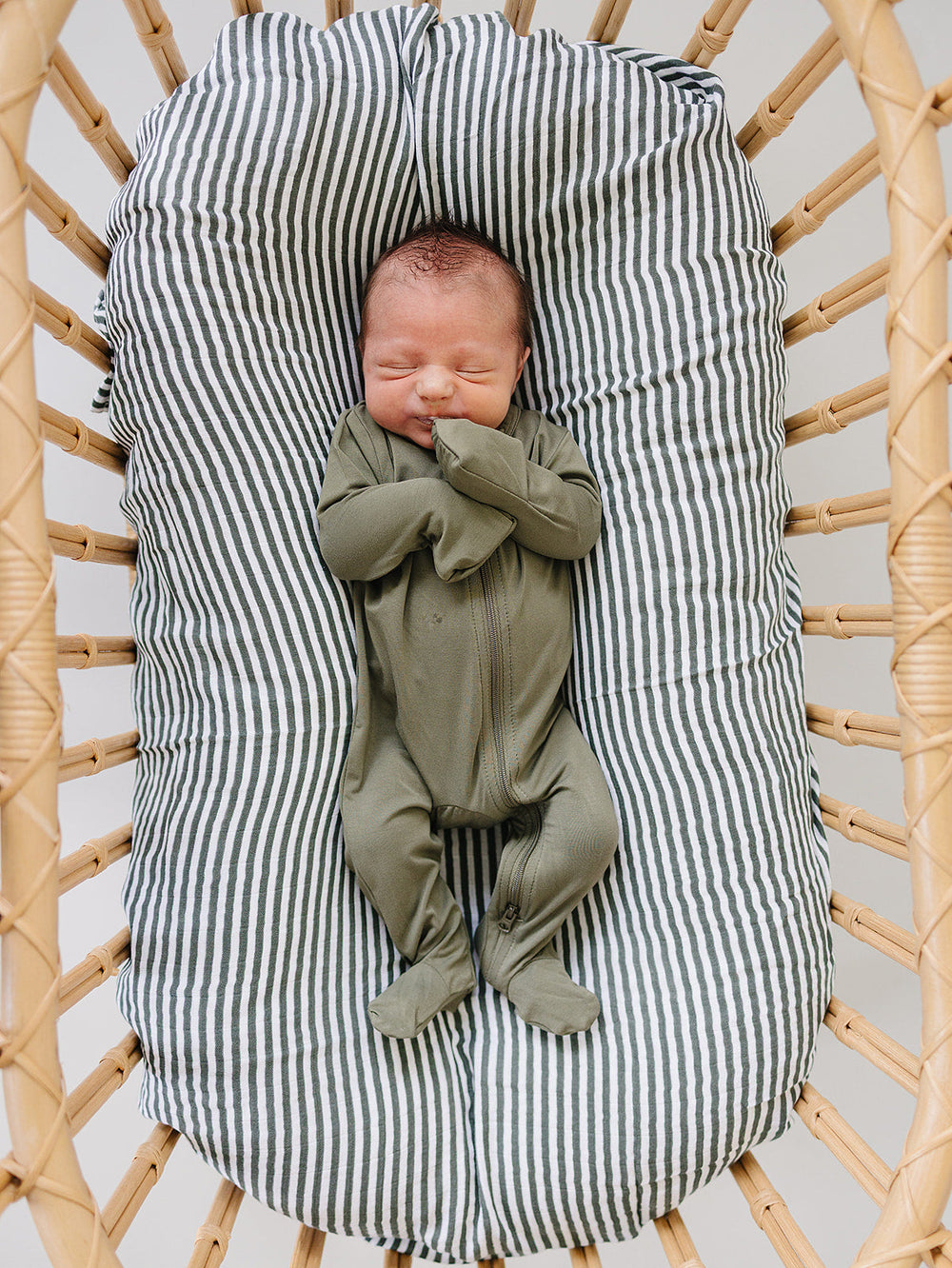 Soft texture close up of the Olive Bamboo Footed Zipper, a gentle footed baby pajama for babies