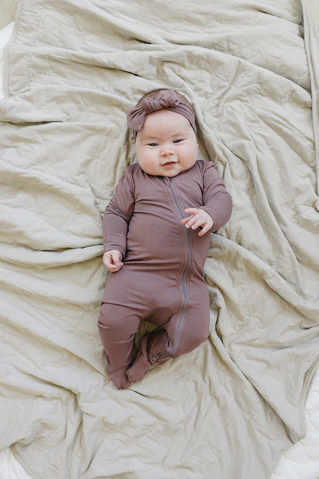 Soft texture close up of the Plum Bamboo Footed Zipper, a gentle footed baby pajama for babies