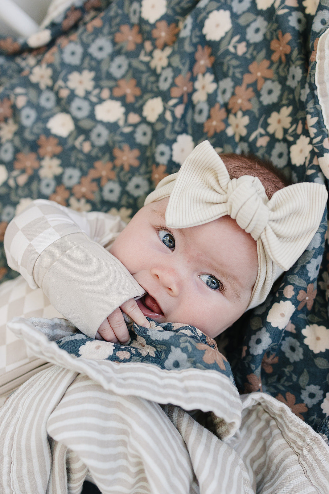 Lifestyle photo of the Taupe Checkered Bamboo Zipper styled as a baby essential for little ones