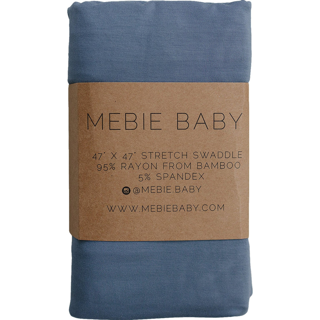 Dusty Blue Bamboo Stretch Swaddle by Mebie Baby, folded on a nursery shelf.
