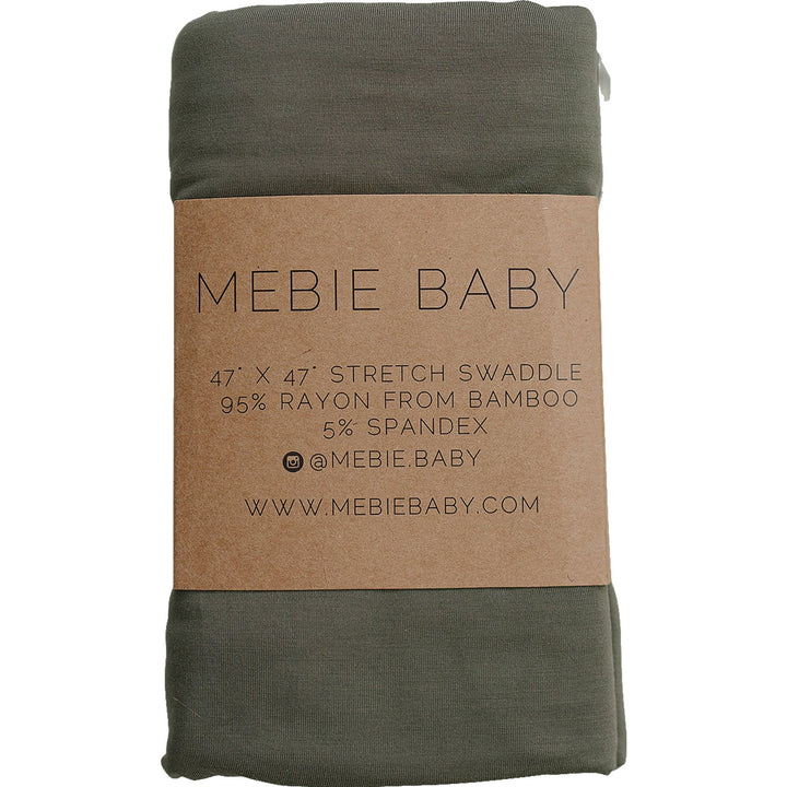 Olive Bamboo Stretch Swaddle by Mebie Baby, folded on a nursery shelf.