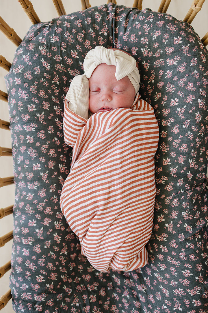 Gently wrap your newborn in the Mebie Baby Pink Stripes Muslin Swaddle Blanket, a perfect muslin swaddle.