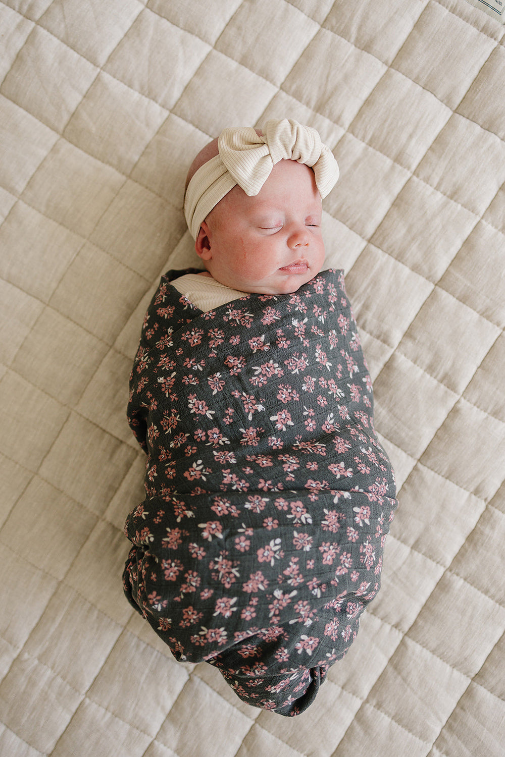 Gently wrap your newborn in the Mebie Baby Olive Bloom Muslin Swaddle Blanket, perfect as muslin swaddle blankets.