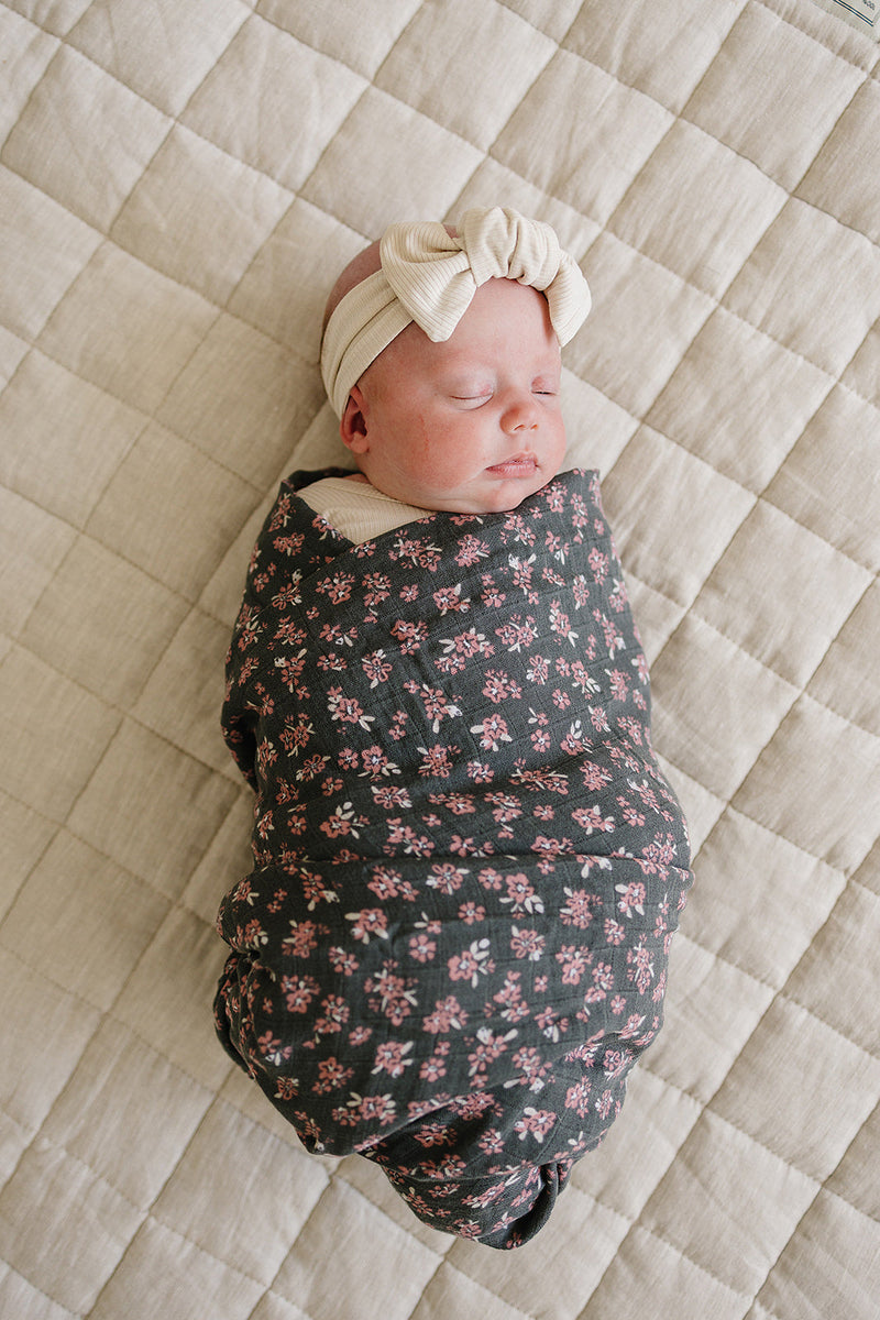 Gently wrap your newborn in the Mebie Baby Olive Bloom Muslin Swaddle Blanket, perfect as muslin swaddle blankets.