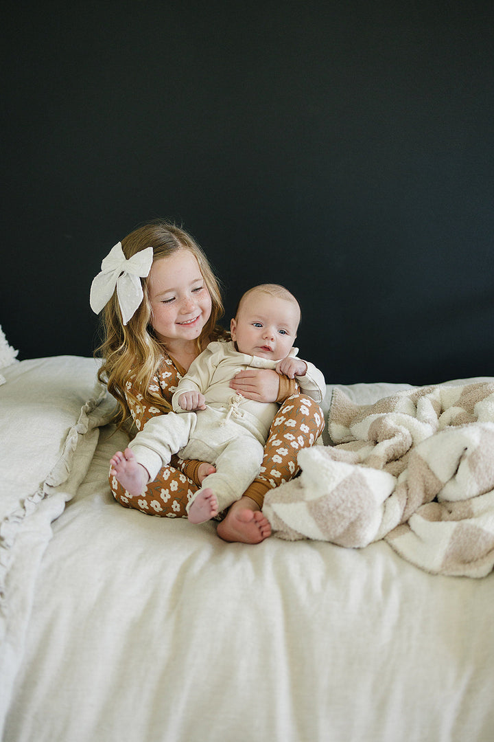 Cream Bamboo Snap Long Sleeve Ribbed Bodysuit shown from a different angle to highlight this bamboo snap bodysuit