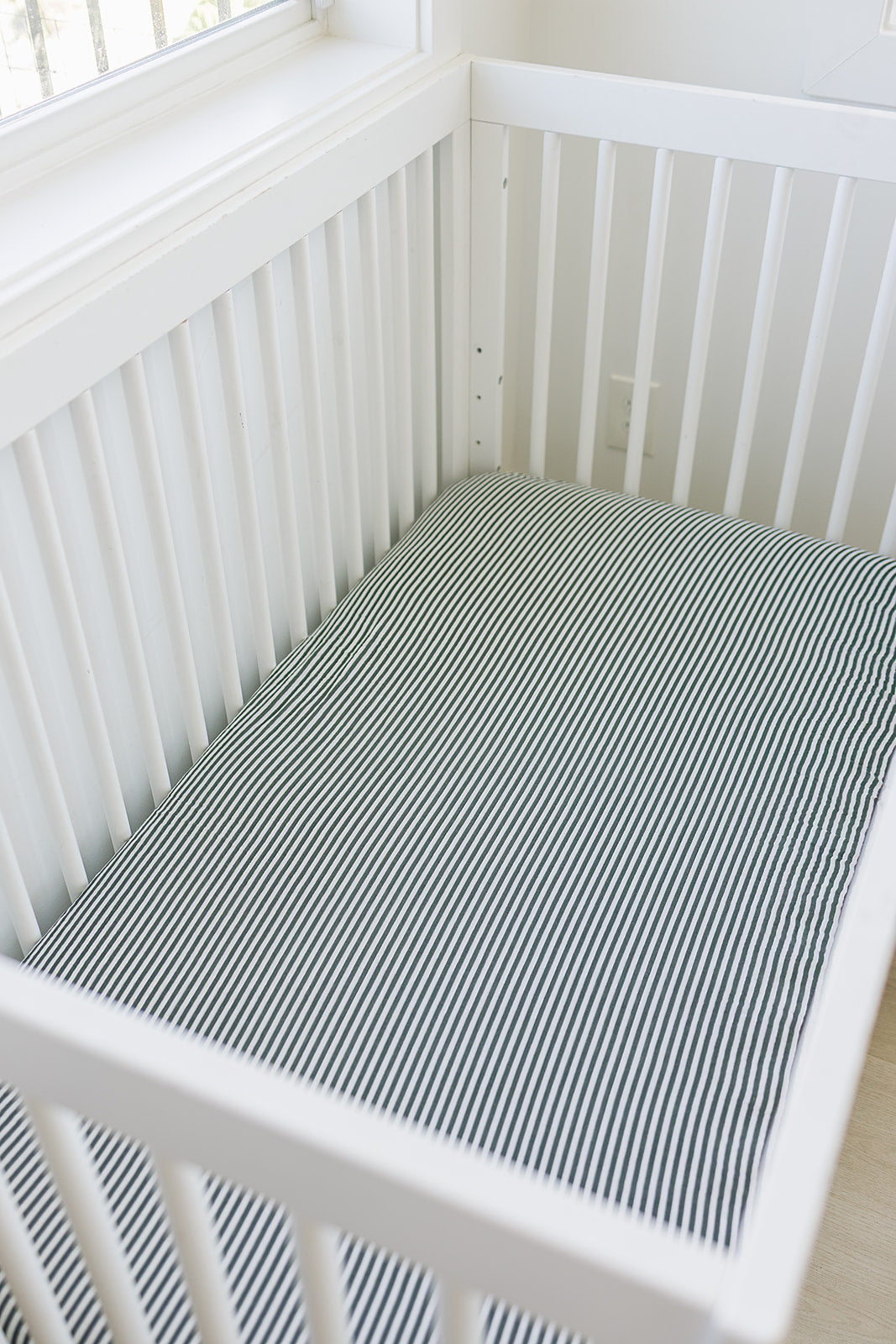 Keep your little one cozy with the Mebie Baby Green Stripes Muslin Crib Sheet, a gentle baby crib sheets option.