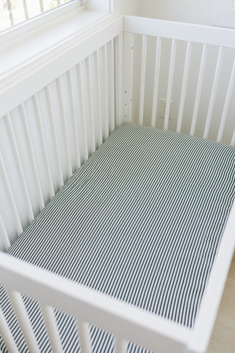 Keep your little one cozy with the Mebie Baby Green Stripes Muslin Crib Sheet, a gentle baby crib sheets option.