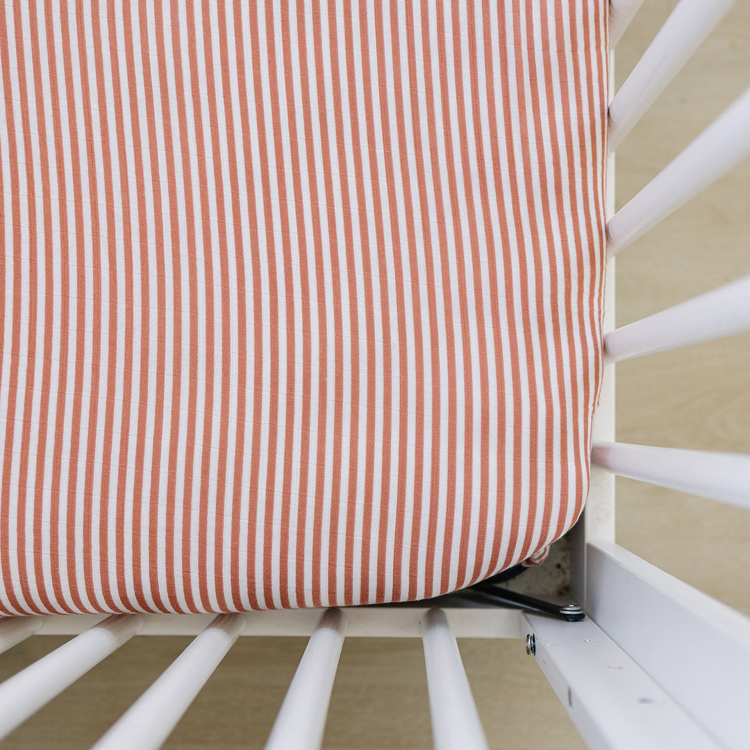 Mebie Baby Pink Stripes Muslin Crib Sheet offers soft, breathable crib sheets for a cozy nursery.